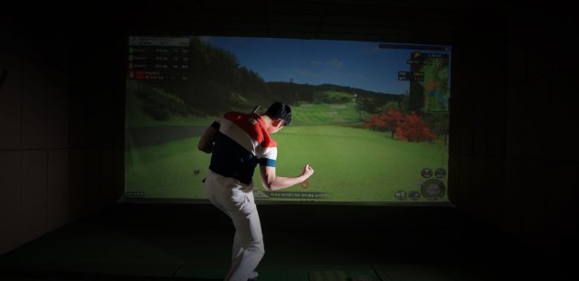 Golfer celebrating successful swing